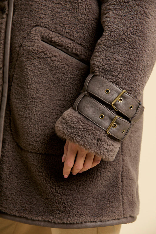 Faux fur coat with leather-effect detail